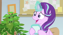 Size: 1600x900 | Tagged: safe, screencap, character:phyllis, character:starlight glimmer, species:pony, species:unicorn, episode:a horse shoe-in, g4, my little pony: friendship is magic, bulletin board, female, house plant, levitation, magic, mare, nervous grin, office, philodendron, picture frame, telekinesis