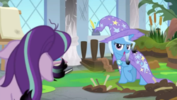 Size: 1600x900 | Tagged: safe, screencap, character:starlight glimmer, character:trixie, species:pony, episode:a horse shoe-in, g4, my little pony: friendship is magic, bog, burnt, cape, cattails, clothing, column, dirt, easel, grass, hat, inkwell, leaves, mess, moss, quill, singed, trixie's cape, trixie's hat, window