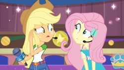 Size: 1280x720 | Tagged: safe, screencap, character:applejack, character:fluttershy, episode:best in show: the victory lap, g4, my little pony:equestria girls, applejack's hat, clothing, cowboy hat, hat, microphone, photo