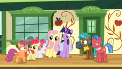 Size: 1366x768 | Tagged: safe, screencap, character:biscuit, character:fluttershy, character:spur, character:twilight sparkle, character:twilight sparkle (alicorn), species:alicorn, species:pony, episode:growing up is hard to do, g4, my little pony: friendship is magic, box, chest, cmc safe, disappointed, door, neckerchief, ribbon, saddle bag, smiling, squint, train station, unamused, window