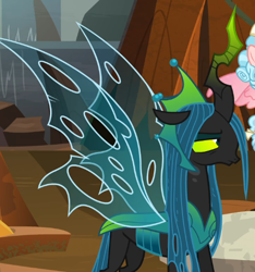 Size: 514x550 | Tagged: safe, screencap, character:cozy glow, character:queen chrysalis, species:changeling, episode:the ending of the end, g4, my little pony: friendship is magic, annoyed, changeling queen, cropped, crown, evil lair, female, filly, former queen chrysalis, grogar's lair, horn, jewelry, lair, queen chrysalis is not amused, regalia, solo focus, spread wings, ultimate chrysalis, unamused, wings