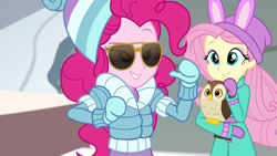 Size: 1920x1080 | Tagged: safe, screencap, character:fluttershy, character:pinkie pie, species:bird, species:owl, equestria girls:holidays unwrapped, g4, my little pony:equestria girls, chad (owl), clothing, coat, duo, duo female, female, fluttershy's winter hat, hat, jacket, mittens, sunglasses, winter coat, winter hat, winter jacket, winter outfit