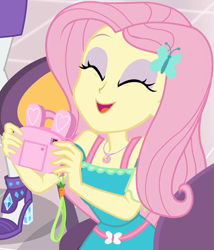 Size: 860x1004 | Tagged: safe, screencap, character:fluttershy, character:rarity, equestria girls:holidays unwrapped, g4, my little pony:equestria girls, bunny ears, camera, canterlot mall, chair, clothing, cropped, cute, dashing through the mall, dress, eyes closed, female, flower, geode of fauna, gift giving, hairclip, happy, jewelry, magical geodes, mall, necklace, present, shyabetes, sitting, smiling, table, waistband