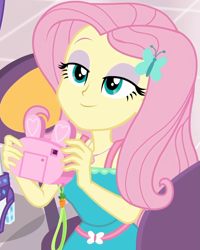 Size: 799x997 | Tagged: safe, screencap, character:fluttershy, character:rarity, equestria girls:holidays unwrapped, g4, my little pony:equestria girls, bunny ears, camera, canterlot mall, clothing, cropped, cute, dashing through the mall, dress, female, flower, geode of fauna, hairclip, happy, jewelry, lidded eyes, looking up, magical geodes, mall, necklace, present, shyabetes, smiling, waistband