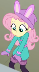 Size: 427x787 | Tagged: safe, screencap, character:fluttershy, equestria girls:holidays unwrapped, g4, my little pony:equestria girls, bird whistle, blizzard or bust, bunny ears, clothing, coat, cropped, cute, female, leg warmers, looking down, mittens, shirt, shyabetes, undershirt, waistband, winter hat, winter outfit