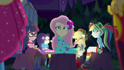 Size: 1920x1080 | Tagged: safe, screencap, character:applejack, character:fluttershy, character:pinkie pie, character:rainbow dash, character:rarity, character:sunset shimmer, character:twilight sparkle, character:twilight sparkle (scitwi), species:eqg human, equestria girls:sunset's backstage pass, g4, my little pony:equestria girls, applejack's festival hat, clothing, cowboy hat, female, flower, flower in hair, food, glasses, hat, humane five, humane seven, humane six, marshmallow, music festival outfit, offscreen character, ponytail, shoes, sitting, sneakers, toasting marshmallows, tree stump, visor