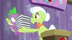Size: 1920x1080 | Tagged: safe, screencap, character:granny smith, character:spike, species:dragon, species:earth pony, species:pony, episode:a trivial pursuit, g4, my little pony: friendship is magic, assistant, baby dragon, bags under eyes, book, claws, duo, elderly, female, floppy ears, flying, granny smith's scarf, hair bun, host, male, mare, shrunken pupils, smiling, spread wings, straining, underfoot, winged spike, wings, wrinkles