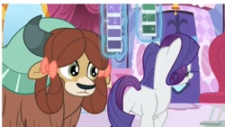 Size: 1920x1080 | Tagged: safe, screencap, character:rarity, character:yona, species:pony, species:unicorn, species:yak, episode:she's all yak, g4, my little pony: friendship is magic, bow, carousel boutique, duo, duo female, female, frown, hair bow, horns, levitation, magic, magic aura, mare, mentor and protege, mentoring, monkey swings, plot, smiling, teenager, telekinesis