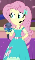 Size: 338x587 | Tagged: safe, screencap, character:fluttershy, episode:best in show: the victory lap, g4, my little pony:equestria girls, cropped, cute, hand on hip, microphone, shyabetes, smiling, solo