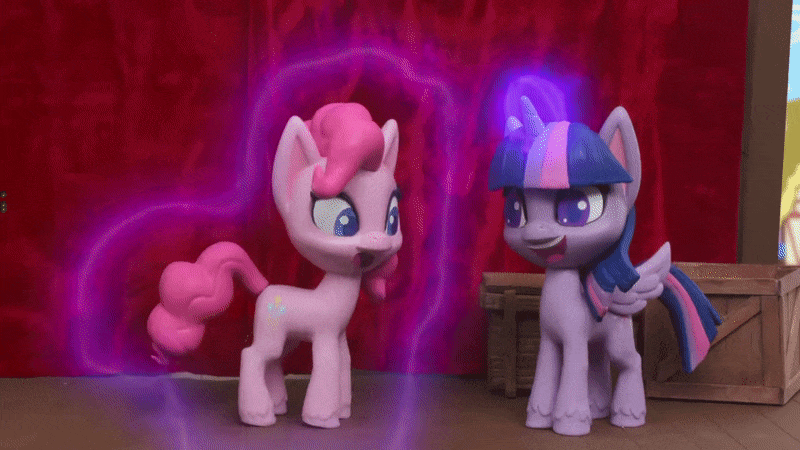 Size: 800x450 | Tagged: safe, screencap, character:pinkie pie, character:twilight sparkle, character:twilight sparkle (alicorn), species:alicorn, species:earth pony, species:pony, g4.5, my little pony: stop motion short, my little pony:pony life, animated, crate, curtains, gif, laughing, levitation, magic, magic aura, magician pinkie pie (short), stage, stop motion, telekinesis, wings