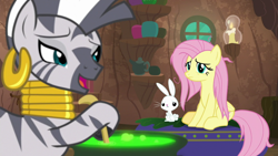 Size: 1920x1080 | Tagged: safe, screencap, character:angel bunny, character:fluttershy, character:zecora, species:pegasus, species:pony, species:rabbit, species:zebra, episode:she talks to angel, g4, my little pony: friendship is magic, animal, cauldron, ear piercing, earring, female, hoof hold, jewelry, male, mare, messy mane, neck rings, piercing, trio, zecora's hut