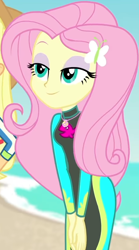 Size: 454x815 | Tagged: safe, screencap, character:applejack, character:fluttershy, equestria girls:forgotten friendship, g4, my little pony:equestria girls, beach, bodysuit, butterfly, clothing, cropped, cute, female, geode of fauna, hairclip, hands together, jewelry, lidded eyes, long sleeves, magical geodes, necklace, ocean, sand, shyabetes, sky, smiling, swimsuit, wetsuit