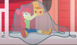 Size: 1482x857 | Tagged: safe, screencap, character:apple bloom, equestria girls:holidays unwrapped, g4, my little pony:equestria girls, adorabloom, apple bloom's bow, boots, bow, box, caught, clothing, cropped, cute, hair bow, house, jack in the box, jack-in-the-box, jeans, lifting, net, pants, shirt, shoes, sitting, solo, surprised, the cider louse fools
