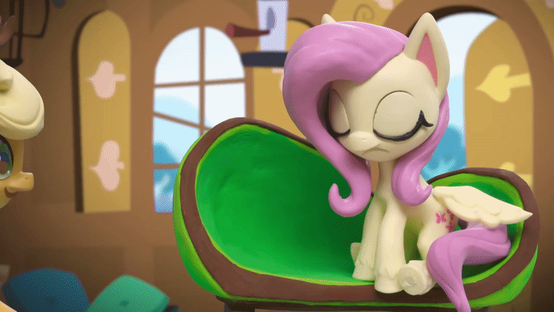 Size: 800x450 | Tagged: safe, screencap, character:applejack, character:fluttershy, species:earth pony, species:pegasus, species:pony, g4.5, my little pony: stop motion short, my little pony:pony life, animated, applejack's hat, chair, clothing, confluttershy, confused, cowboy hat, door, excited, eyes closed, fluttershy's cottage (interior), fluttershy's hiccups, food, fruit, gif, happy, hat, holding up, lemon, looking at something, stop motion, window, wings