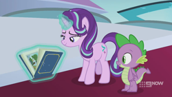 Size: 1280x720 | Tagged: safe, screencap, character:spike, character:starlight glimmer, species:dragon, species:pony, species:unicorn, episode:memories and more, 9now, book, levitation, magic, magic aura, scrapbook, telekinesis, winged spike