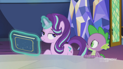 Size: 1280x720 | Tagged: safe, screencap, character:spike, character:starlight glimmer, species:dragon, species:pony, species:unicorn, episode:memories and more, 9now, bedroom eyes, book, duo, levitation, magic, magic aura, mid-blink screencap, scrapbook, smiling, smug, telekinesis, winged spike