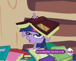 Size: 945x761 | Tagged: safe, screencap, character:twilight sparkle, species:pony, species:unicorn, episode:secret of my excess, g4, my little pony: friendship is magic, book, book hat, derp, floppy ears, golden oaks library, horn impalement, hub logo, open mouth, reaction image, solo