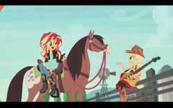 Size: 1024x645 | Tagged: safe, screencap, character:applejack, character:sunset shimmer, episode:friendship through the ages, g4, my little pony:equestria girls, country applejack, farm, guitar, horse, humans riding horses, open mouth, riding, sidesaddle, sitting, sleeveless, smiling