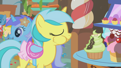 Size: 1280x720 | Tagged: safe, screencap, character:diamond mint, character:lemony gem, character:white lightning, species:pegasus, species:pony, species:unicorn, episode:call of the cutie, g4, my little pony: friendship is magic, background pony, clothing, cupcake, eyes closed, female, flower, flower in hair, food, mare, puffy cheeks, saddle, skirt, tack