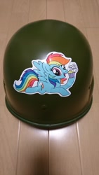 Size: 1152x2048 | Tagged: artist needed, safe, character:rainbow dash, species:pegasus, species:pony, cupcake, female, flying, food, helmet, irl, mare, open mouth, photo, smiling, solo