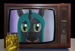 Size: 2560x1752 | Tagged: artist needed, source needed, safe, character:queen chrysalis, species:changeling, 3d, food, irl, looking at you, photo, pickle, solo, television