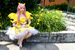 Size: 900x600 | Tagged: artist needed, safe, character:angel bunny, character:fluttershy, species:human, 2012, animenext, choker, clothing, convention, cosplay, dress, high heels, irl, irl human, photo, sitting, solo