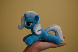 Size: 3008x2000 | Tagged: safe, artist:lanacraft, character:trixie, species:human, species:pony, species:unicorn, hand, in goliath's palm, irl, kittensized, lidded eyes, photo, plushie, prone, smiling