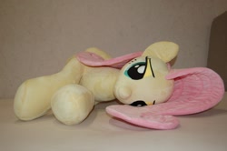 Size: 2400x1596 | Tagged: safe, artist:lanacraft, character:fluttershy, species:pegasus, species:pony, female, irl, lidded eyes, lying down, mare, on side, photo, plushie, solo