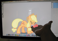 Size: 1140x796 | Tagged: safe, artist:egophiliac, character:applejack, species:human, apple, computer, eyes closed, fourth wall, hand, irl, irl human, mac os x, operating system, photo, ponies in real life, tongue out