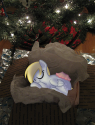 Size: 900x1184 | Tagged: safe, artist:egophiliac, character:derpy hooves, species:pegasus, species:pony, christmas, christmas tree, cute, dawwww, eyes closed, female, mare, on side, present, sleeping, smiling, solo, tree, was muffins, wrapper