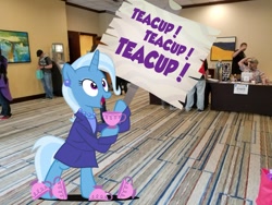 Size: 1200x900 | Tagged: safe, artist:pixelkitties, character:trixie, species:human, species:pony, species:unicorn, bipedal, clothing, cup, ear piercing, earring, everfree northwest, irl, irl human, jewelry, necklace, photo, photoshop, piercing, ponies in real life, sign, solo, teacup, that pony sure does love teacups