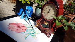 Size: 1920x1080 | Tagged: safe, artist:nedemai, oc, oc only, species:pony, species:unicorn, newbie artist training grounds, atg 2021, clock, irl, mantel clock, painting, photo, solo, toy, traditional art, watercolor painting
