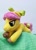 Size: 858x1200 | Tagged: safe, artist:basil_leafeon, character:posey bloom, species:earth pony, species:pony, g5, adoraposey, bow, cute, floppy plush, hair bow, lying down, photo, plush