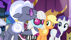 Size: 1600x900 | Tagged: safe, screencap, character:applejack, character:hoity toity, character:photo finish, character:rarity, episode:honest apple, g4, my little pony: friendship is magic, apple family member, clothing, cowboy hat, cuffs (clothes), dress, fashion show, glasses, hat, looking at someone, smiling