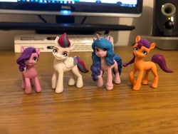 Size: 4032x3024 | Tagged: safe, character:izzy moonbow, character:pipp petals, character:sunny starscout, character:zipp storm, species:earth pony, species:pegasus, species:pony, species:unicorn, g5, my little pony: a new generation, female, figurine, gradient hair, irl, mare, multicolored hair, photo, pipp is small, pipp wings, toy