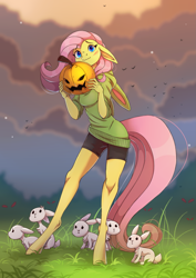 Size: 1897x2676 | Tagged: safe, artist:lambibelle, character:fluttershy, species:anthro, species:bird, species:pegasus, species:rabbit, species:unguligrade anthro, g4, animal, beautiful, blue eyes, blushing, bunny ears, clothing, cloud, compression shorts, cute, evening, female, floppy ears, food, grass, halloween, holiday, hoodie, jack-o-lantern, looking at you, mare, pink mane, pink tail, pumpkin, shorts, shyabetes, standing, sweater, wavy mouth, yellow fur